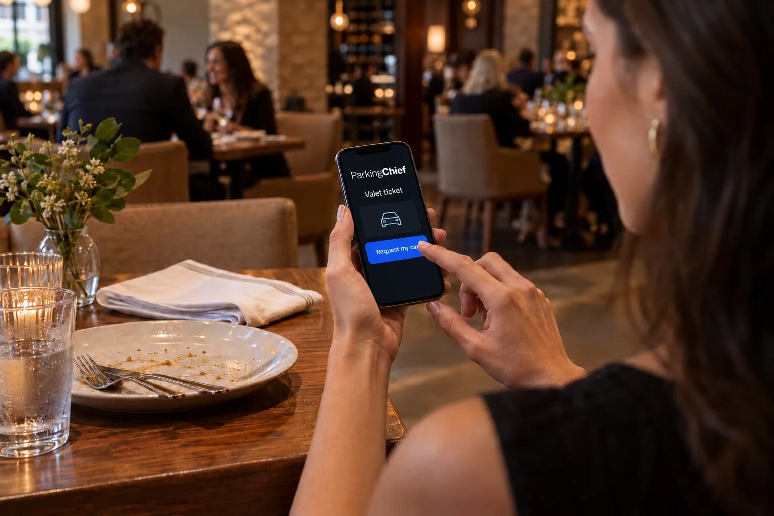Guest inside a restaurant using a ParkingChief valet ticket to request their car